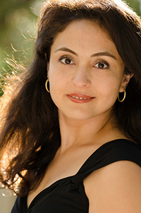 In this portrait, Katrin has much more flattering lighting and she's wearing a plain black dress, so the viewer's focus is on her gorgeous eyes, not on what she's wearing]