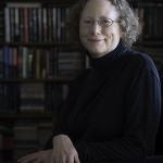 Author M. Louisa Locke strikes a classic author pose in front of her personal library